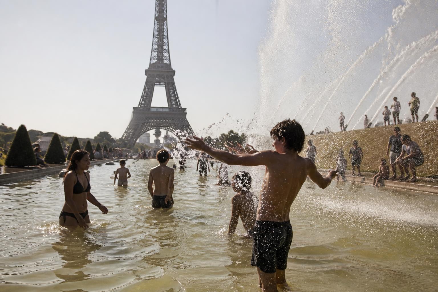Parisians cooling off in the Trocadero Fountain during the June 2026 European heat dome
